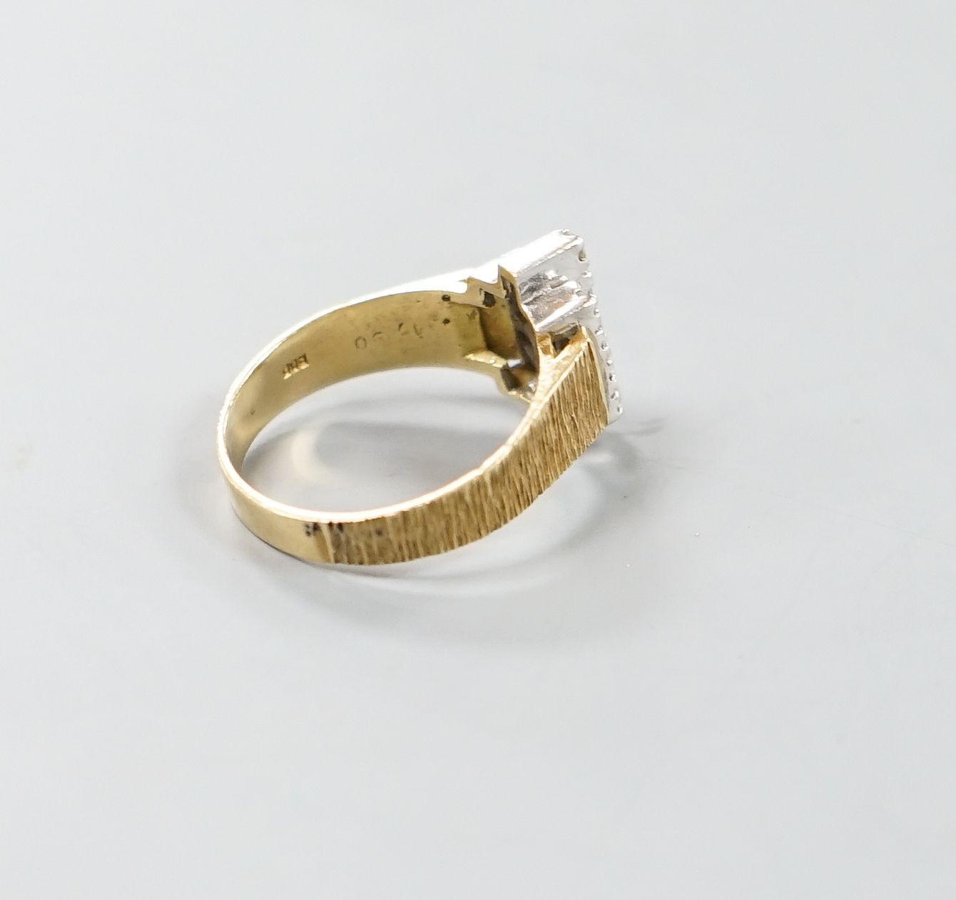 A 1970's textured 18ct gold and thirteen stone diamond set geometric dress ring, size Q, gross weight 5.3 grams.